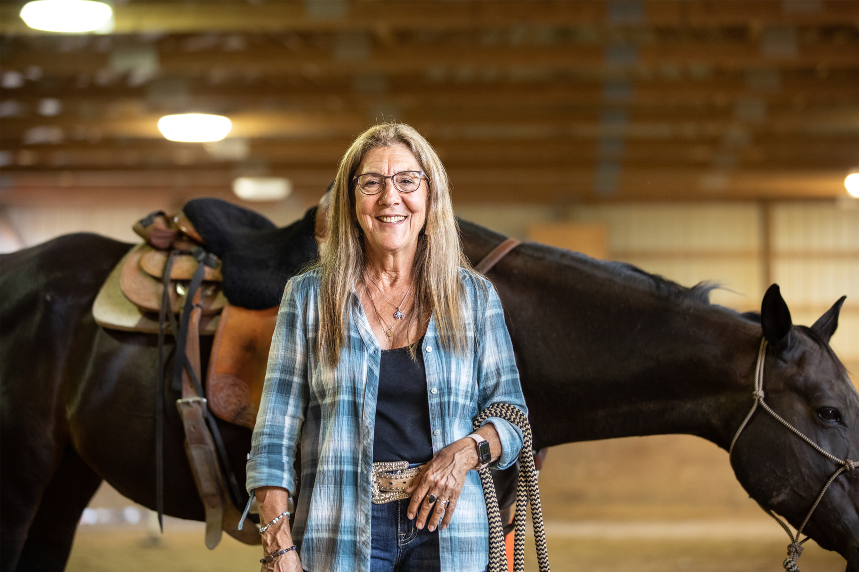 Lynn the owner standing in front of her horse.